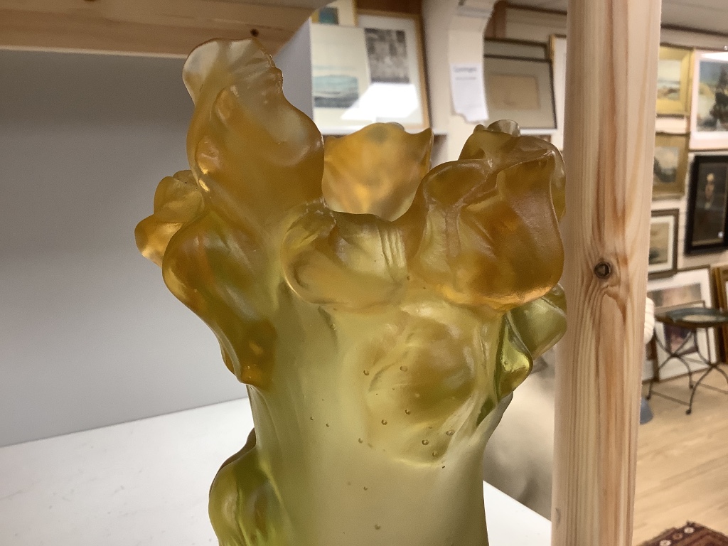 An amber vase with a nude study in relief, apocryphal Daum mark, 24cm high